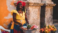 Woman stands at a fruit stall