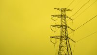 Image of power lines in front of a yellow background